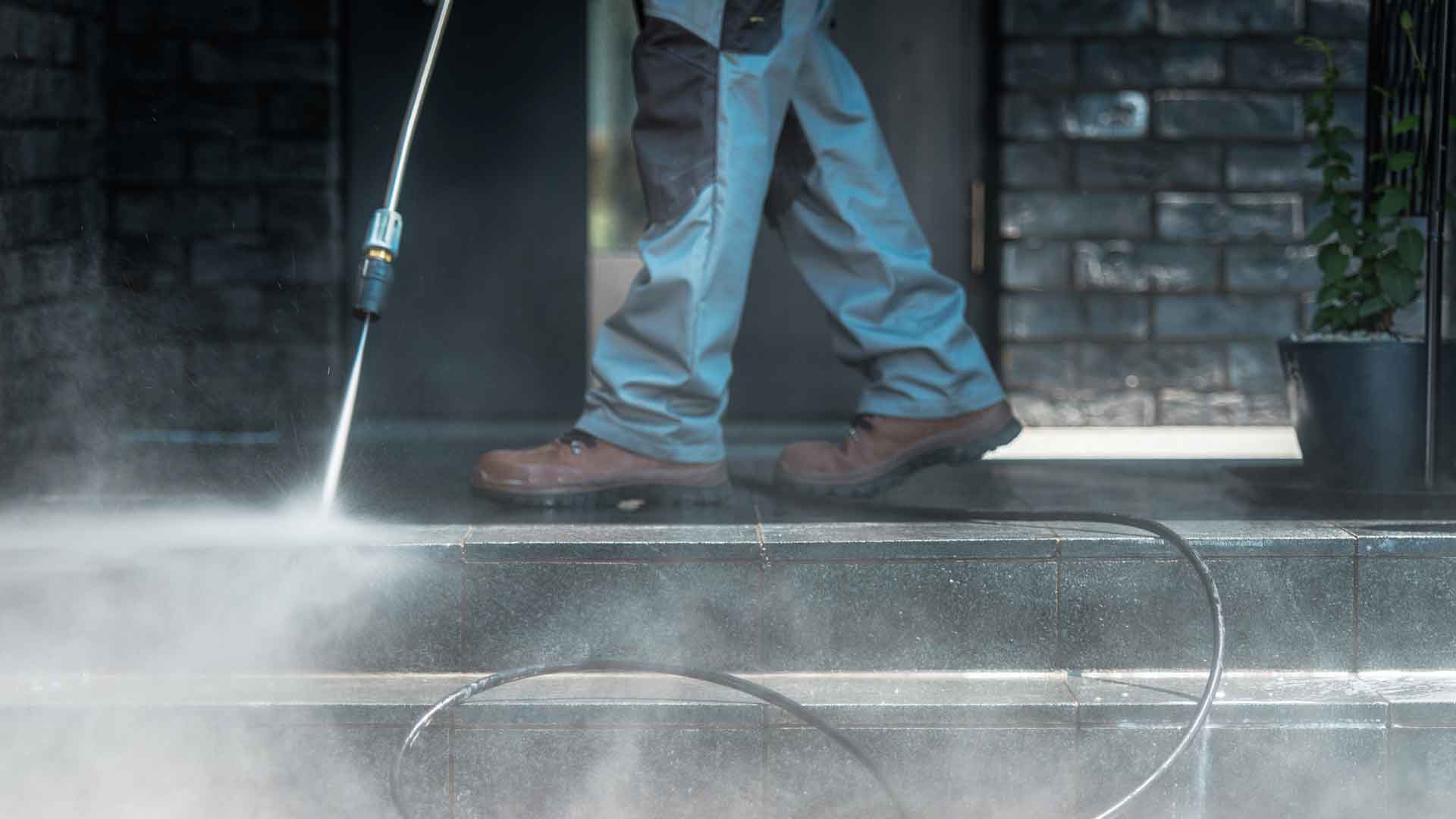 SGT. STEAM crew pressure washing a building exterior